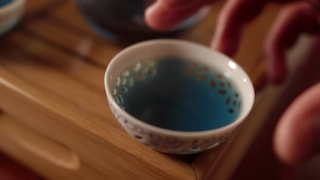 Man Takes the Porcelain Bowl with Thailand Blue Tea