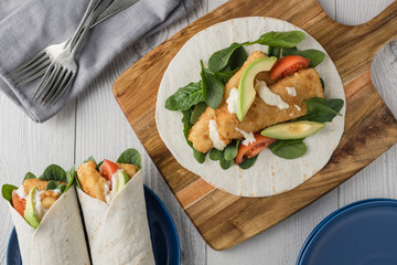 Fish finger wraps with avocado and tomato