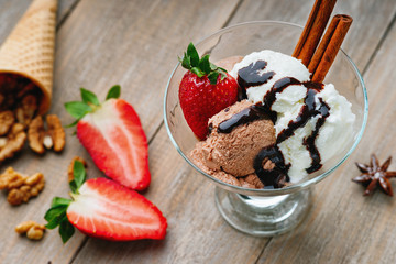 Ice cream sundae, waffle cone, walnuts and strawberry 