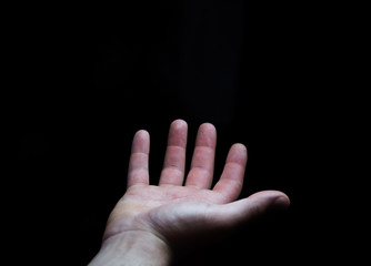 Businessman hand on black dark background