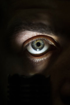 male eye with flashlight