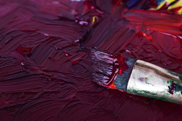 Dirty paint brush in mixed purple paint