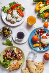 Greek appetizers  - fritters of zucchini, Greek salad, yogurt.