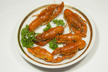 boiled crawfish with greens on a platter