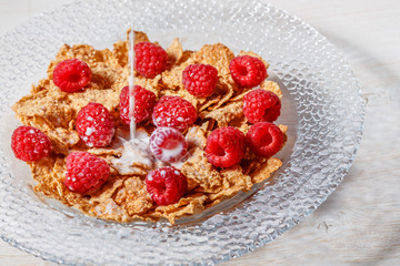 Wheat flakes with raspberries and milk.