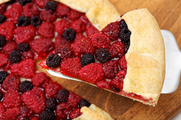 Piece of galette with red and black raspberries