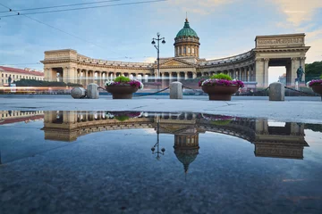 Deurstickers Russia, Saint-Petersburg, 03 July 2016: Reflection of Kazan Cathedral in a pool on the sidewalk of the Nevsky of the prospectus, after a rain, tourists, sunset, water mirror, long exposure lights © Vladimir Drozdin