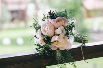 Beautiful  wedding bouquet with cones, cotton . Bride holding a