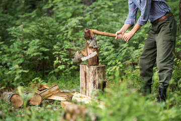a man chopping wood in the forest