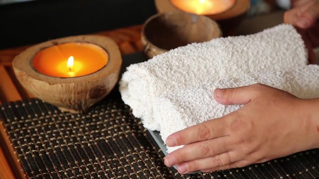 massag in spa salon. candle burns, masseur puts the towels