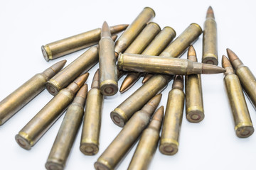 old rifle cartridges 5.56 mm on a white background