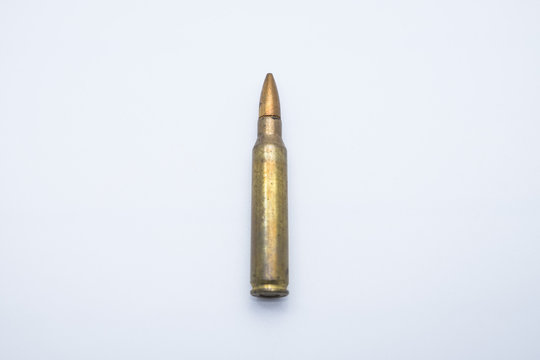 old rifle cartridges 5.56 mm on a white background