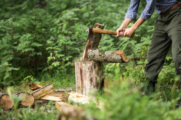 a man chopping wood in the forest