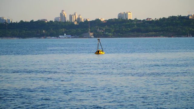 Yellow buoy in sea water as safety warning