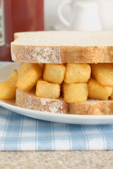 Chip butty potato chips or french fries in a sandwich