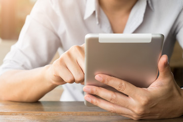 Close up of a young man using mobile smart phone and tablet focus on his hand with mining light