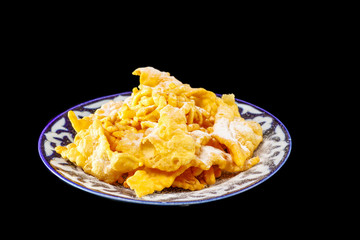 Oriental sweets on a black mirror background, isolated.