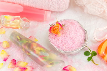 Red and yellow roses with massage oil and bath salt