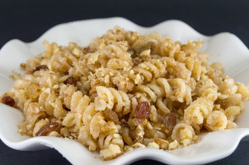 Sweet pasta with honey, nuts and raisins