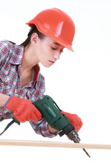 Portrait of young female builder in helmet with drill on white