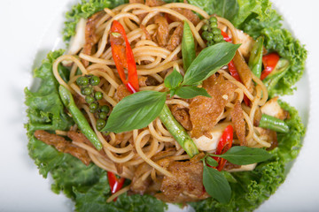 Spaghetti pasta with tomatoes and parsley on wooden table.  (Veg