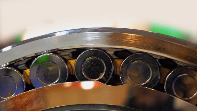 Chrome surface of the roller bearing shines brightly in different colors