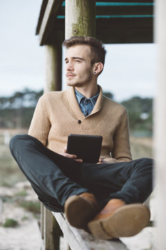 Young Man Using Technology in a Nature Setting