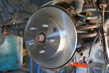 close up on wheel hub and disk brake, car repair