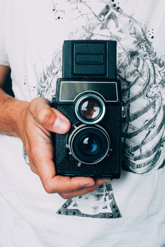 Man Holding a Retro Camera