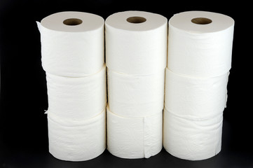 toilet paper rolls on black background