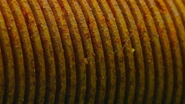 Main drum, old and rusty but functioning, of an old fashioned, hand crank powered, mechanical latex press in a rural processing operation in Southeast Asia. Video 1920x1080