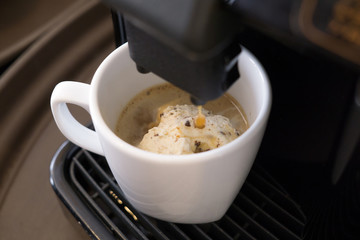 coffee machine makes a hot coffee with icecream