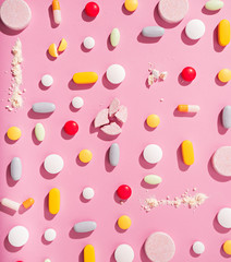 concept theme.bright pills on pink background