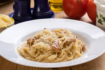 spaghetti carbonara on wooden table