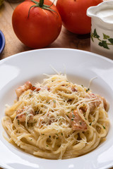 spaghetti carbonara on wooden table