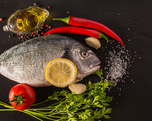 fish with vegetables on a stone slate