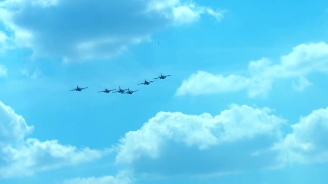 SLO MO WIDE TILT Formation of military fighter jets flying towards the horizon against blue sky. 120 FPS 