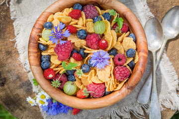 Tasty flowers and fruits with cornflakes