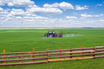 Tractor spraying field farm 