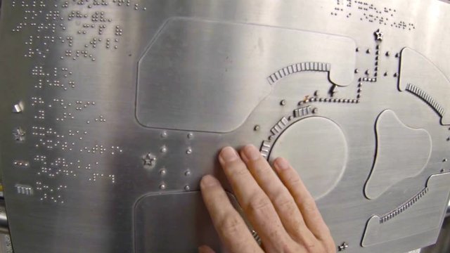 Map and information directory printed in braille on a stainless steel sign for the blind in Hong Kong, China.