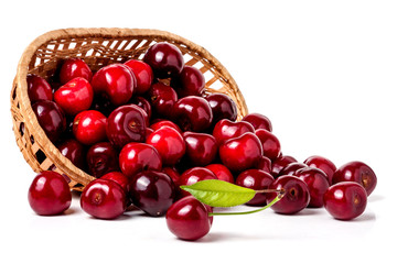 cherries in a wicker basket isolated on white background