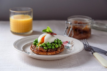 Sandwich with poached egg, bacon on plate  dark background