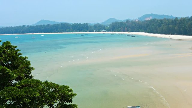 Video 4k - Beautiful, exotic, tropical beach at low tide, under a bright blue sumer sky in southern Thailand. Top view