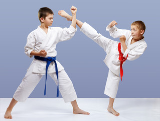 Kick leg and block are doing sportsmen in karategi © andreyfire