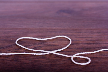 White string on a rustic wooden surface