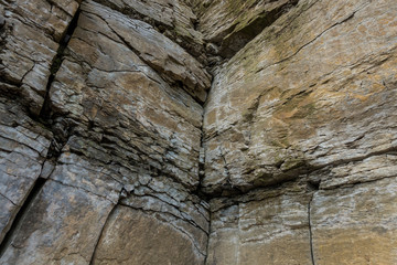.Stone wall of rock with cracks