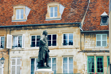 Street scene in the old French village Langres. Statue of Denis Diderot
