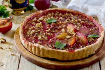 Plum cake shortbread dough with walnuts on a table in a rustic s