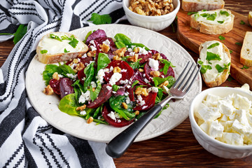 Healthy Beet Salad with fresh sweet baby spinach, kale lettuce, nuts, feta cheese and toast with melted cheese