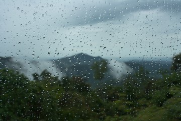 Moinsoon rain drops on the bus window glass © kkolis